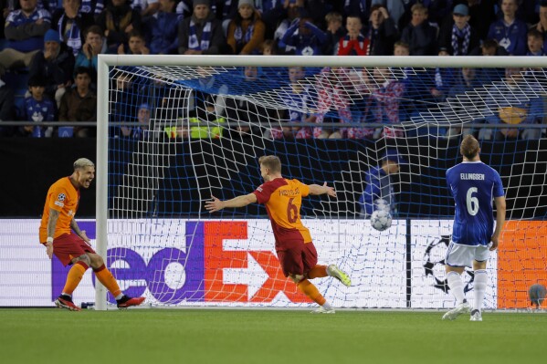 Galatasaray's Fredrik Midtsjo, center, scores during the playoff match for the Champions League soccer match between Molde and Galatasaray at Aker Stadion, Molde, Norway, Wednesday Aug. 23, 2023. (Svein Ove Ekornesvag/NTB via AP)