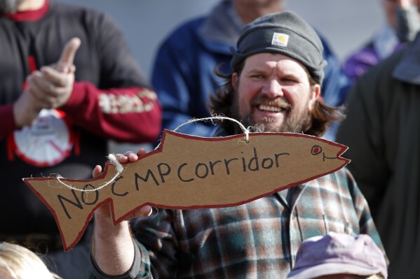 FILE - Matt Wagner, of Knox, Maine, attends a rally after supporters of "No CMP Corridor" submitted more than 75,000 signatures to election officials at the State Office Building in Augusta, Maine, Feb. 3, 2020. If voters grant their approval on Tuesday, Nov. 7, 2023, Maine would be the 10th state to close the loophole in federal election law that bans foreign entities from spending on candidate elections, yet allows donations for local and state ballot measures. (AP Photo/Robert F. Bukaty, File)