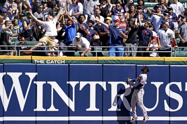 Minnesota Twins center fielder Gilberto Celestino, right, watches as fans try to catch Chicago White Sox's Zack Collins's home run during the sixth inning of a baseball game in Chicago, Thursday, July 1, 2021. (AP Photo/Nam Y. Huh)