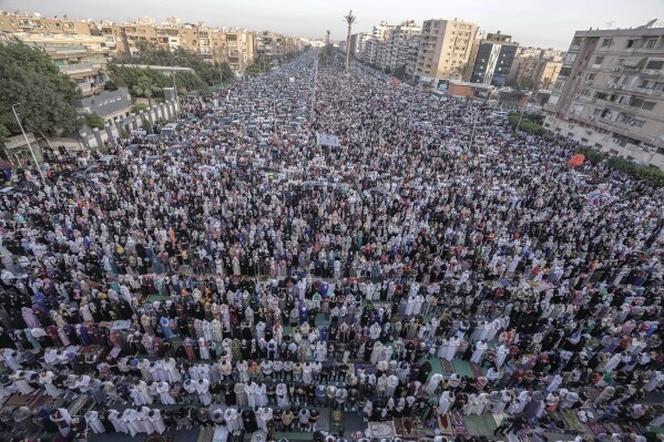 FILE - Egyptian Muslims perform Eid al-Fitr prayers outside al-Seddik mosque in Cairo, Egypt, Friday, April 21, 2023. In the Middle East and North Africa, where religion is often ingrained in daily life's very fabric, rejecting faith can come with social or other repercussions, so many of the 