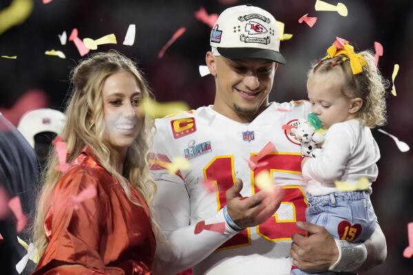 Kansas City Chiefs quarterback Patrick Mahomes (15) and his wife Brittany, left, celebrate with their daughter, Sterling Skye Mahomes, after the NFL Super Bowl 57 football game, Sunday, Feb. 12, 2023, in Glendale, Ariz. The Kansas City Chiefs defeated the Philadelphia Eagles 38-35. (AP Photo/Seth Wenig)