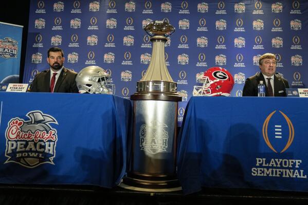 Ohio State head coach Ryan Day, left and Georgia head coach Kirby Smart address the media during a news conference ahead of Saturday's Peach Bowl NCAA college football game Friday, Dec. 30, 2022, in Atlanta. (AP Photo/John Bazemore)