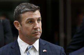 FILE - This Dec. 3, 2019 file photo shows California Republican Rep. Duncan Hunter leaveing federal court in San Diego. Hunter submitted his resignation Tuesday, Jan. 7, 2020, effective Jan. 13, after pleading guilty to a corruption charge, leaving one of the GOP's few remaining House seats in heavily Democratic California. Hunter's departure ends his family's political dynasty in which he and his father, Duncan L. Hunter, represented the San Diego County district for nearly 30 years. (AP Photo/Gregory Bull, File)