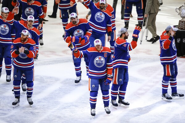Edmonton Oilers players wave to fans after defeating the Dallas Stars in Game 6 of the Western Conference finals of the NHL hockey Stanley Cup playoffs in Edmonton, Alberta, Sunday, June 2, 2024. (Jeff McIntosh/The Canadian Press via AP)