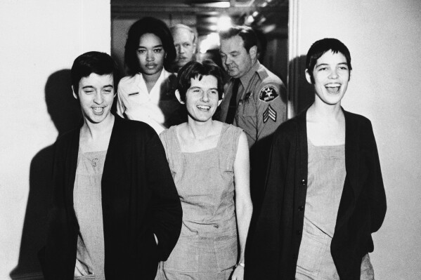 FILE - Three women co-defendants in the Sharon Tate murder case, from left, Susan Atkins, Patricia Krenwinkel and Leslie Van Houten, laugh as they walk to court in Los Angeles for sentencing on March 29, 1971. Van Houten, one of Charles Manson's followers, was released from prison on parole on Tuesday, July 11, 2023. (AP Photo/File)