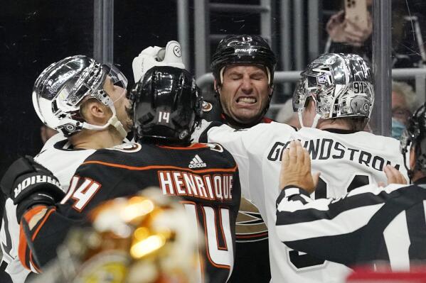 Anaheim Ducks center Ryan Getzlaf, second from right, scuffles with Los Angeles Kings right wing Dustin Brown, left, and right wing Carl Grundstrom, right, as center Adam Henrique gets involved after Grundstrom collided with Ducks goaltender Anthony Stolarz during the second period of an NHL hockey game Saturday, April 23, 2022, in Los Angeles. (AP Photo/Mark J. Terrill)