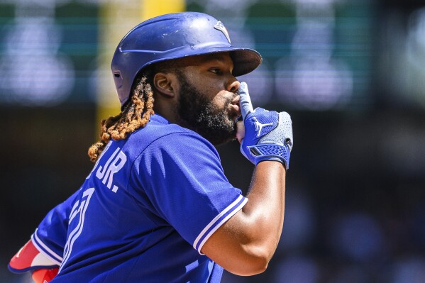 Toronto Blue Jays' Vladimir Guerrero Jr. gestures as he rounds the bases after hitting a two-run home run during the fourth inning of a baseball game against the Seattle Mariners, Sunday, July 23, 2023, in Seattle. (AP Photo/Caean Couto)