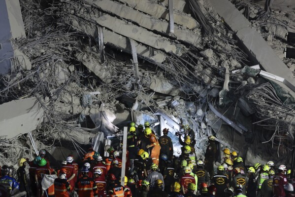 Rescuers work at the site of a high-rise building under construction that collapsed after a 7.7 magnitude earthquake in Bangkok, Thailand, early Saturday, March 29, 2025. (AP Photo/Wason Wanichakorn)