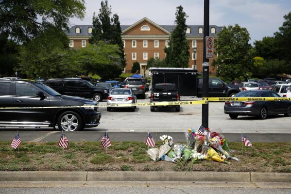 FILE - A makeshift memorial rests at the edge of a police cordon in front of a municipal building that was the scene of a shooting in Virginia Beach, Va., June 1, 2019. Several members of a state commission tasked with conducting an independent investigation of the 2019 mass shooting in Virginia Beach, have stepped down in recent months in the latter part of 2022, raising doubts among some whether the panel can perform its job. (AP Photo/Patrick Semansky, File)