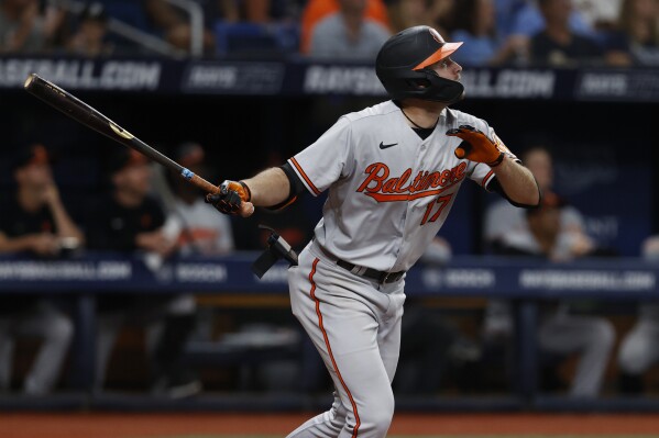Baltimore Orioles' Colton Cowser watches his RBI sacrifice fly against the Tampa Bay Rays during the 10th inning of a baseball game Thursday, July 20, 2023, in St. Petersburg, Fla. (AP Photo/Scott Audette)