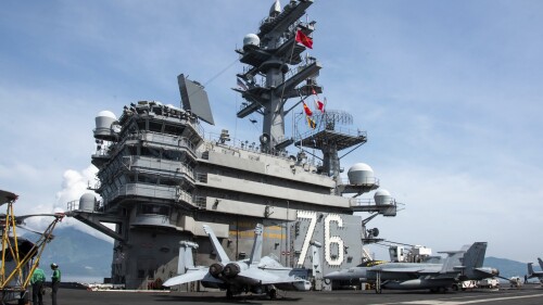 In this photo provided by U.S. Navy, the United States and Vietnam national ensigns are raised in unison on the USS Ronald Reagan (CVN 76) in Da Nang, Vietnam, for a port visit, Sunday, June 25, 2023. The American aircraft carrier made a port call in Vietnam on Sunday — a rare visit by one of the U.S. Navy’s biggest ships that comes as Washington and Beijing both step up efforts to bolster ties with Southeast Asian nations.(Mass Communication 3rd Class Eric Stanton/U.S. Navy via AP)