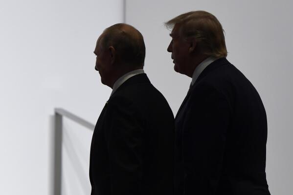 FILE - In this June 28, 2019, file photo, President Donald Trump and Russian President Vladimir Putin walk to participate in a group photo at the G20 summit in Osaka, Japan.  (AP Photo/Susan Walsh, File)