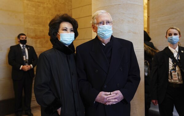 Senate Majority Leader Mitch McConnell, right, and his wife, former Secretary of Transportation Elaine Chao, arrive at the East Front of the U.S. Capitol ahead of President-elect Joe Biden’s inaugu...
