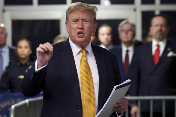 FILE - Former President Donald Trump speaks to reporters at Manhattan Criminal Court, May 21, 2024 in New York. Trump has spent the majority of his time as a criminal defendant sitting nearly motionless for hours, leaning back in his chair with his eyes closed. It is in part a strategy in response to warnings that behaving like he has in past trials could backfire. Trump has also been able to speak several times a day to a gaggle of media camped outside the courtroom, giving him an outlet to vent his frustrations. (Michael M. Santiago/Pool Photo via AP, File)