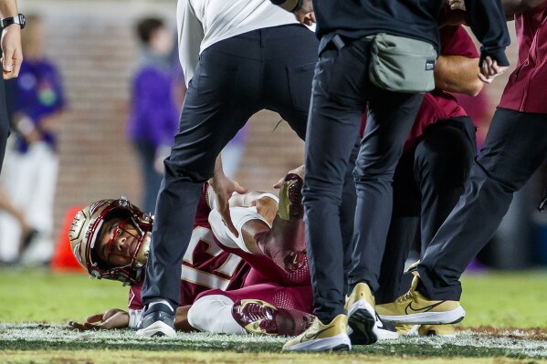 Florida State quarterback Jordan Travis receives attention on the field after being injured during the first half of the team's NCAA college football game against North Alabama, Saturday, Nov. 18, 2023, in Tallahassee, Fla. (AP Photo/Colin Hackley)