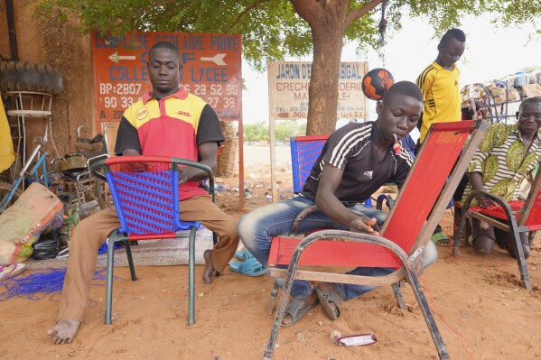 Nigerian men repair chairs in Niamey, Niger, Tuesday, Aug. 15, 2023. Niger, an impoverished country of some 25 million people, was seen as one of the last countries that Western nations could partner with in Africa's Sahel region to beat back a jihadi insurgency linked to al-Qaida and the Islamic State group. Before last month's coup, Europe and the United States had poured hundreds of millions of dollars into propping up its military. (AP Photo/Sam Mednick)