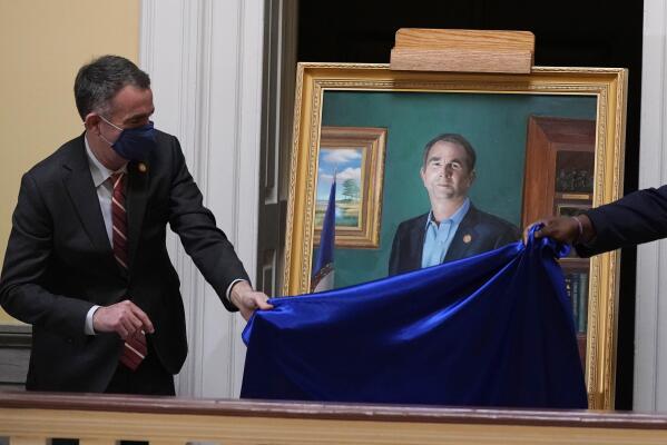 Virginia Gov. Ralph Northam unveils his portrait at the Capitol Tuesday Jan. 11, 2022, in Richmond, Va. Northam's portrait, which will hang on the third floor of the Capitol, includes references to the many issues he dealt with during his term. (AP Photo/Steve Helber)