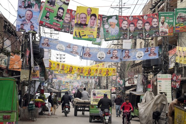 Party banners of election candidates from political parties are displayed on a street ahead of Feb. 8 general elections in Lahore, Pakistan, Feb. 3, 2024. (AP Photo/K.M. Chaudary)