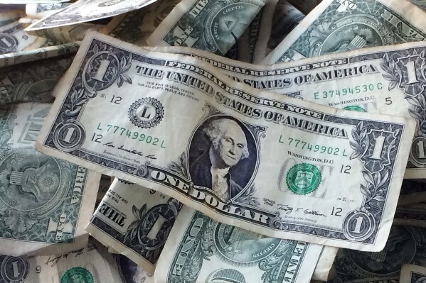 This Oct. 24, 2016 file photo shows dollar bills in New York. (AP Photo/Mark Lennihan, File)