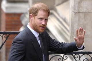 FILE - Britain's Prince Harry salutes media as he arrives at the Royal Courts of Justice in London, on March 30, 2023. Prince Harry is expected to return to the U.K. next month to attend a charity awards ceremony on the eve of the first anniversary of Queen Elizabeth II’s death. (AP Photo/Kirsty Wigglesworth, File)