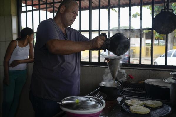 Julio Alvarez brews coffee at the kitchen of his farm in the outskirts of Barinas, Venezuela, Sunday, Dec. 5, 2021. Alvarez hasn't sold any milk in about two years even though the cows at his farm in rural northwestern Venezuela are milked around dawn every day. Serious fuel shortages and rationing made it impossible for him to transport it, except in plastic containers strapped around a motorcycle, and forced him to start making much-less-profitable cheese. (AP Photo/Ariana Cubillos)