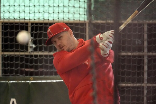Los Angeles Angles' Mike Trout hits in the cages during a baseball spring training workout, Monday, Feb. 19, 2024, in Tempe, Ariz. (APPhoto/Matt York)