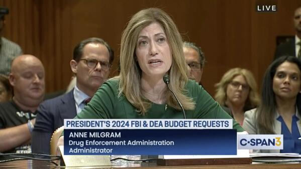 In this image from video provided by C-SPAN, U.S. Drug Enforcement Administration Administrator Anne Milgram speaks during a hearing before the Senate Appropriations Subcommittee on Commerce, Justice, and Science in Washington on May 10, 2023. At center left behind Milgram is Louis Milione. After temporarily leaving the DEA in 2017, like dozens of colleagues in the agency's powerful-but-little-known Office of Diversion Control, Milione immediately went to work as a consultant for some of the same companies he had been tasked with regulating, including Morris & Dickson. He was named deputy administrator in 2021. On another front, a federal watchdog is investigating whether Milgram improperly awarded millions of dollars in no-bid contracts to hire her past associates. (C-SPAN via AP)