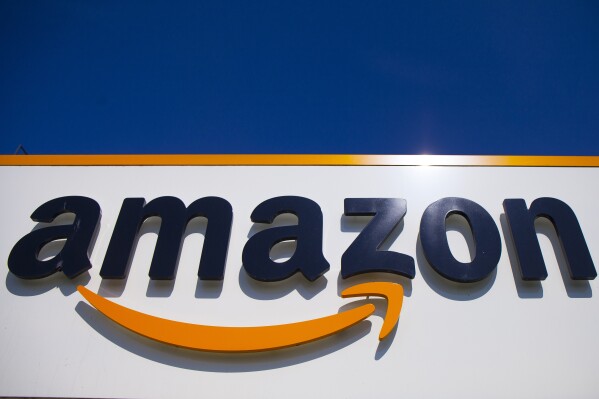 FILE - The Amazon logo is seen in Douai, northern France, April 16, 2020. Amazon is disputing its status as an online platform subject to stricter scrutiny under new European Union digital rules that are set to take effect next month. The ecommerce giant filed a legal challenge with a top European Union court, arguing it's being treated unfairly by being designated a “very large online platform” under the 27-nation bloc's pioneering Digital Services Act. (AP Photo/Michel Spingler, File)