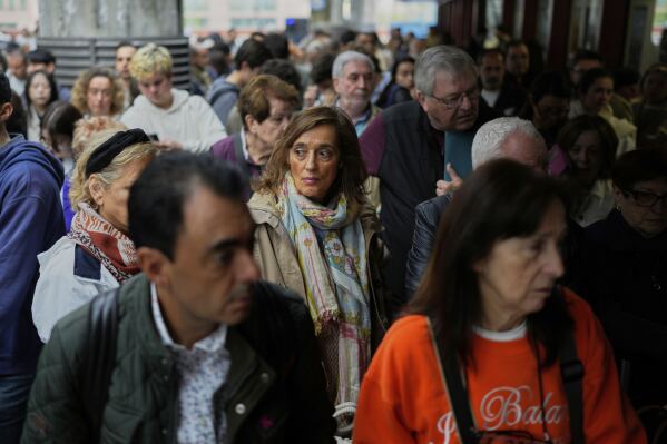 Travelers wait on the platforms for news about their delayed trains at the Madrid train station, Spain, Monday, May 5, 2025. (AP Photo/Manu Fernandez)
