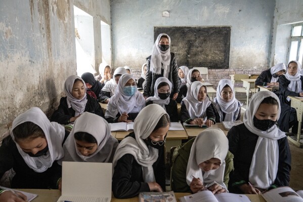 FILE - Afghan school girls attend their classroom on the first day of the new school year, in Kabul, March 25, 2023. The Taliban must embrace and uphold human rights obligations in Afghanistan, the U.N. mission in the country said Sunday on Human Rights Day and the 75th anniversary of the Universal Declaration of Human Rights. (AP Photo/Ebrahim Noroozi, File)