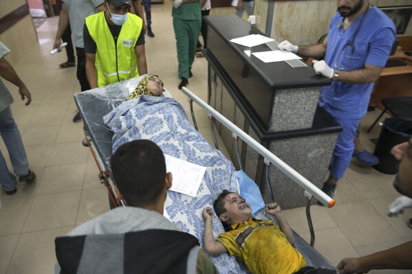Palestinians wounded in Israeli bombardment are brought to a hospital in Deir al-Balah, southern Gaza Strip, Tuesday, Oct. 17, 2023. (AP Photo/Hatem Moussa)