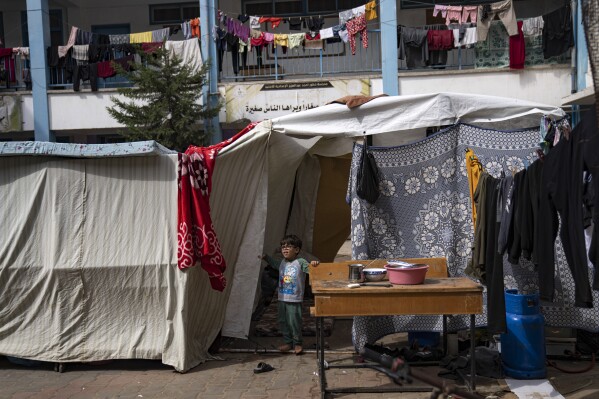 Palestinians take shelter from the Israeli bombardment at a school in Khan Younis in the Gaza Strip, on Monday, Oct. 16, 2023. (AP Photo/Fatima Shbair)