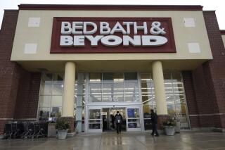 FILE - Bed-Bath-&-Beyond-Strategic-Update,Shoppers enter and exit a Bed Bath & Beyond in Schaumburg, Ill., Jan. 14, 2021. Shares of Bed Bath & Beyond plunged in premarket trading Wednesday, Aug. 31, 2022, after the struggling home goods retailer announced a restructuring that includes store closures, layoffs and a stock offering. The company plans to close about 150 namesake stores but will keep its buybuy Baby chain. (AP Photo/Nam Y. Huh, File)