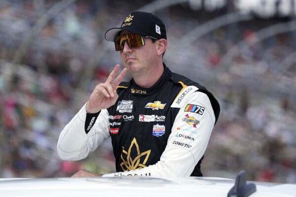 Kyle Busch gestures during introductions before a NASCAR Cup Series auto race at Texas Motor Speedway in Fort Worth, Texas, Sunday, Sept. 24, 2023. (AP Photo/LM Otero)