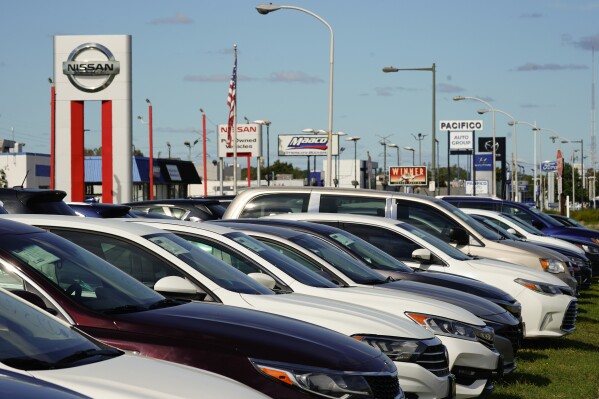 FILE - Cars for sale line the road at a used auto dealership in Philadelphia, Thursday, Sept. 29, 2022. The Federal Reserve’s expected move Wednesday, July 26, 2023, to raise interest rates for the 11th time could once again send ripple effects across the economy. (AP Photo/Matt Rourke, FILE)