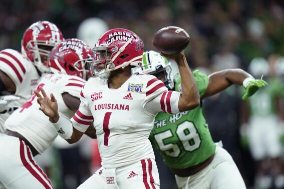 Louisiana-Lafayette quarterback Levi Lewis (1) passes under pressure from Marshall defensive lineman Elijah Alston (58) in the first half of the New Orleans Bowl NCAA football game in New Orleans, Saturday, Dec. 18, 2021. (AP Photo/Gerald Herbert)