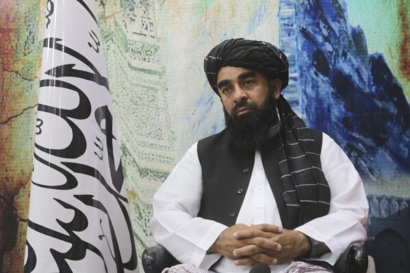 The Taliban's spokesman, Zabihullah Mujahid, sits during an interview in Kandahar, Afghanistan, Monday, Aug. 14, 2023. On the second anniversary of their takeover of the country, Mujahid said the Taliban will stay in power for a long time - and for as long as God wants. (AP Photo/Abdul Khaliq)