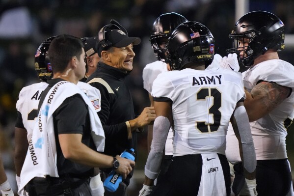 FILE - Army head coach Jeff Monken talks to his his players during the first half of an NCAA college football game against Wake Forest in Winston-Salem, N.C., Saturday, Oct. 8, 2022. The American Athletic Conference has been in contact with Army as it looks for a replacement for Atlantic Coast Conference-bound SMU, according to two people with direct knowledge of the discussions. (AP Photo/Chuck Burton, File)