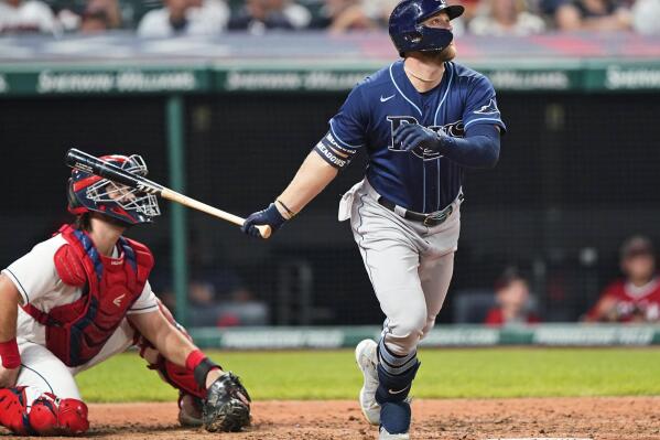 Tampa Bay Rays' Austin Meadows watches his two-run home run next to Cleveland Indians catcher Austin Hedges in the ninth inning of a baseball game Saturday, July 24, 2021, in Cleveland. (AP Photo/Tony Dejak)
