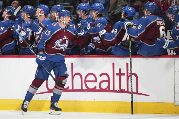 Colorado Avalanche right wing Valeri Nichushkin (13) is congratulated for a goal against the Chicago Blackhawks during the third period of an NHL hockey game Wednesday, Oct. 12, 2022, in Denver. Colorado won 5-2. (AP Photo/Jack Dempsey)
