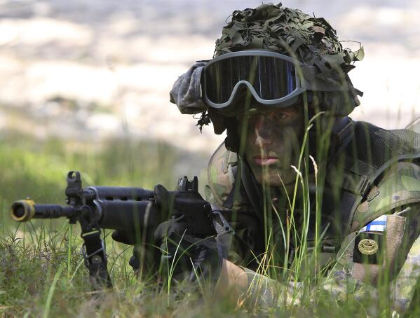 FILE - A Finnish soldier participates in the amphibious operations as part of NATO sea exercises BALTOPS 2015 in Ustka, Poland, on June 17, 2015. NATO Secretary-General Jens Stoltenberg said Monday Finland will become the 31st member of the world's biggest military alliance on Tuesday, prompting a warning from Russia that it would bolster its defenses near their joint border if NATO deploys any troops in its new member. (AP Photo/Czarek Sokolowski, File)