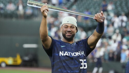 National League's Elias Díaz (35), of the Colorado Rockies, holds up his MVP award after the MLB All-Star baseball game in Seattle, Tuesday, July 11, 2023. The National League won 3-2. (AP Photo/Ted S. Warren)