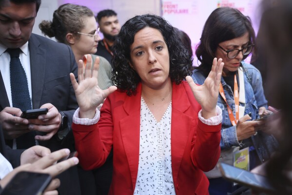 Manon Aubry, a member of the far-left France Insoumise (France Unbowed) party gestures shortly before the release of projections based on the actual vote count in select constituencies, in Paris, Sunday, June 30, 2024. (AP Photo/Thomas Padilla)