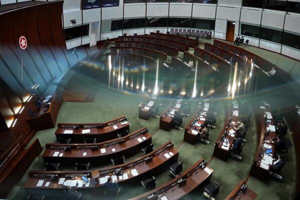 Pro-China lawmakers attend the second meeting of "Improving Electoral System (Consolidated Amendments) Bill 2021" at the Legislative Council in Hong Kong Thursday, May 27, 2021. Hong Kong’s legislature on Thursday moved closer towards amending electoral laws that would drastically reduce the public’s ability to vote for lawmakers and increase the number of pro-Beijing lawmakers making decisions for the city. (AP Photo/Vincent Yu)