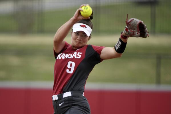 FILE - Arkansas pitcher Autumn Storms throws a pitch against Arkansas-Pine Bluff during an NCAA softball game on Tuesday, April 16, 2019 in Fayetteville, Ark. Arkansas did something rare during the 2017-18 and 2018-19 seasons: It watched its baseball and softball teams both reach the NCAA tournament. The similarities end there.(AP Photo/Michael Woods, File)