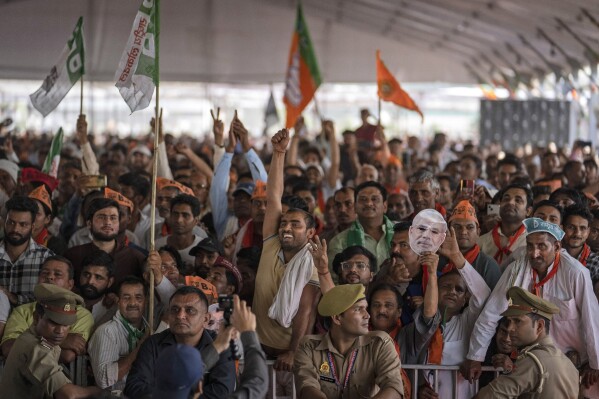 FILE- Supporters of India's ruling Bharatiya Janata Party (BJP) react as they listen to Indian Prime Minister Narendra Modi speak at an election rally in Meerut, India, March 31, 2024. (AP Photo/Altaf Qadri, File)