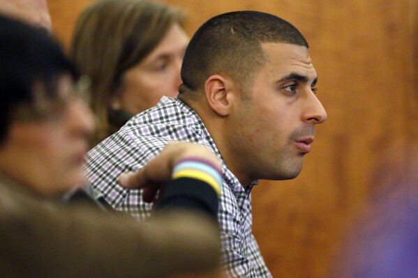 FILE - Dennis Hernandez, brother of former New England Patriots NFL football player Aaron Hernandez, watches during his brother's murder trial on Jan. 29, 2015, in Fall River, Mass. Former UConn football player Dennis Hernandez is behind bars after a witness told police she believed he was planning a school shooting. The 37-year-old, who went by DJ while playing for the Huskies as a quarterback and receiver in the mid-2000s, is due in court on Aug. 1 on charges including threatening. (AP Photo/Steven Senne, Pool, File)