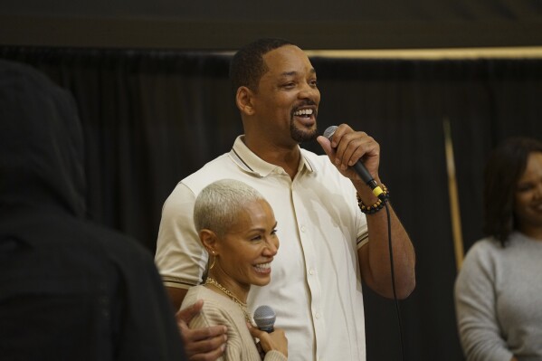 This photo provided by Enoch Pratt Free Library shows Jada Pinkett Smith and Will Smith at the Enoch Pratt Free Library in Baltimore on Wednesday, Oct. 18, 2023. Will Smith joined Jada Pinkett Smith on stage as she promoted her new memoir in her hometown Wednesday night, pledging lifelong support for her just a week after she revealed that the couple had been separated since 2016.(John Cassini /Enoch Pratt Free Library via AP)
