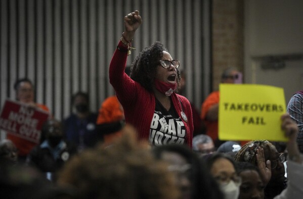 Wanda Mosley, national field director of Black Voters Matter, yells during a community information session about the state takeover of Houston's Independent School District on Thursday, March 30, 2023, at Kashmere High School in Houston. "Where was the takeover when the grid failed?" she asked. (Jon Shapley/Houston Chronicle via AP)