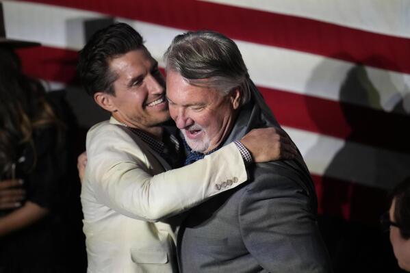 Joe O'Dea, right, Republican nominee to run for the U.S. Senate seat held by Democrat Michael Bennet, is hugged by his son-in-law David Freund on the stage before speaking at a primary election night watch party, Tuesday, June 28, 2022, in Denver. (AP Photo/David Zalubowski)